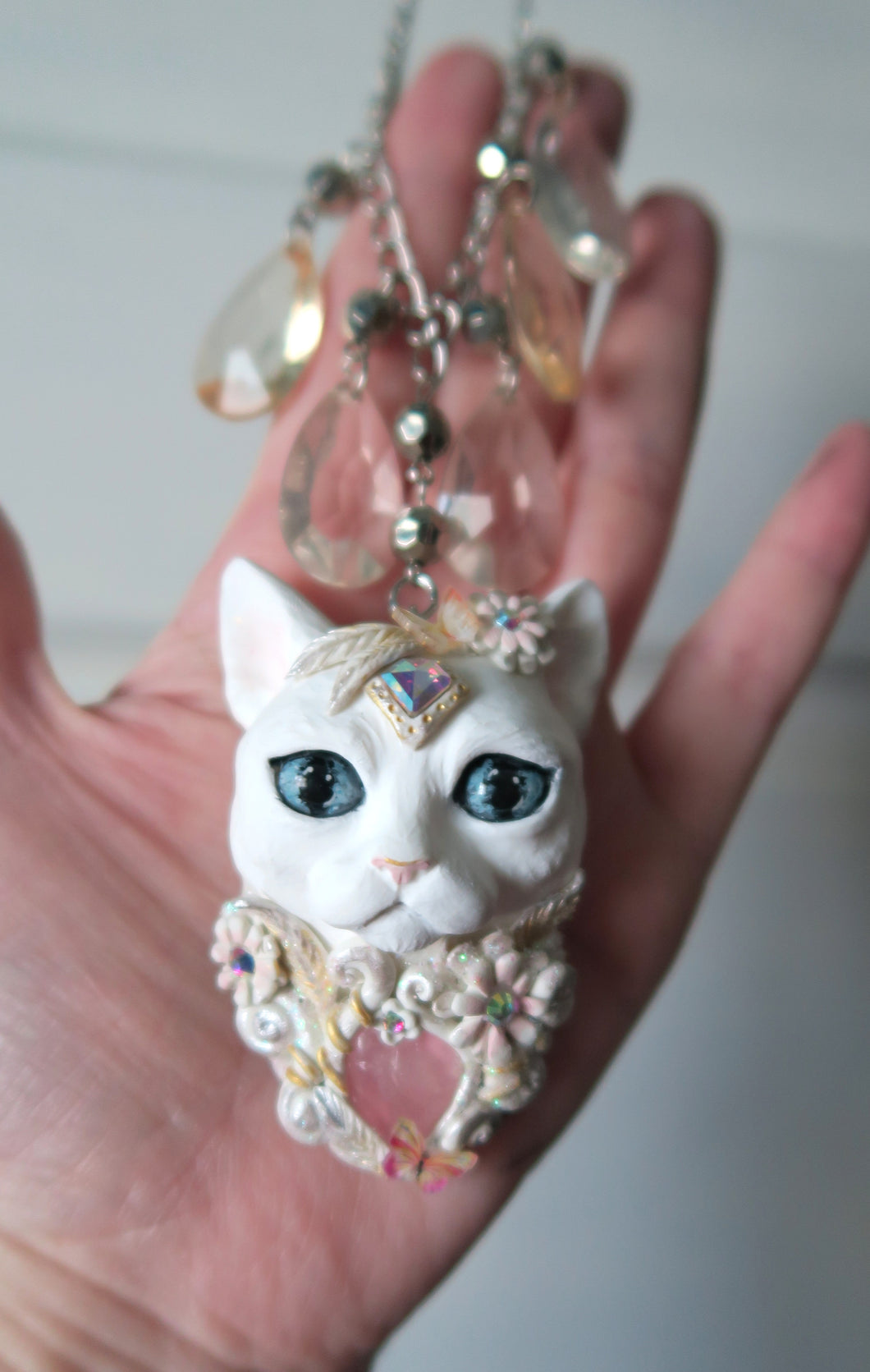 White Cat with Butterflies, Flowers, Feathers, and Crystals Painted Pendant Necklace